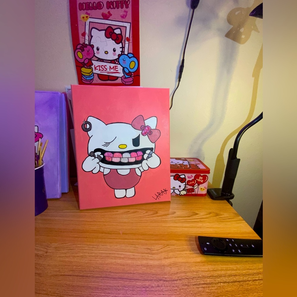 Three Hello Kitty paintings